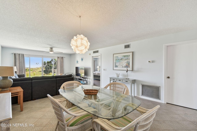 dining room featuring a textured ceiling and ceiling fan