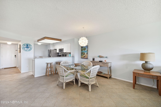 dining room with a textured ceiling