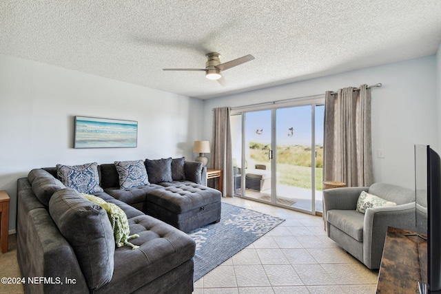 tiled living room with a textured ceiling and ceiling fan