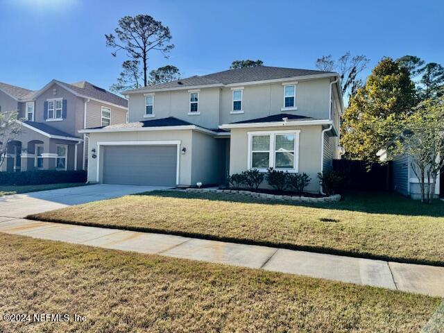 front of property with a garage and a front yard