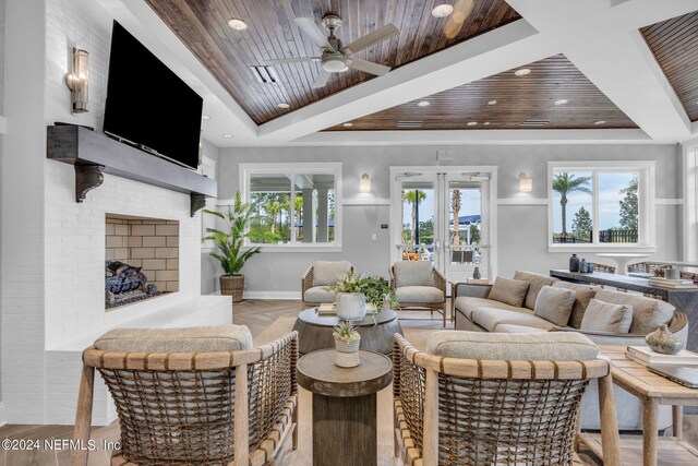 living room with wooden ceiling, french doors, a brick fireplace, light hardwood / wood-style flooring, and ceiling fan