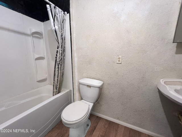 bathroom featuring hardwood / wood-style floors, toilet, and shower / bath combo