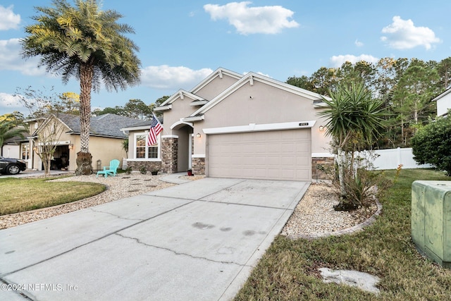 view of front of house with a garage and a front yard