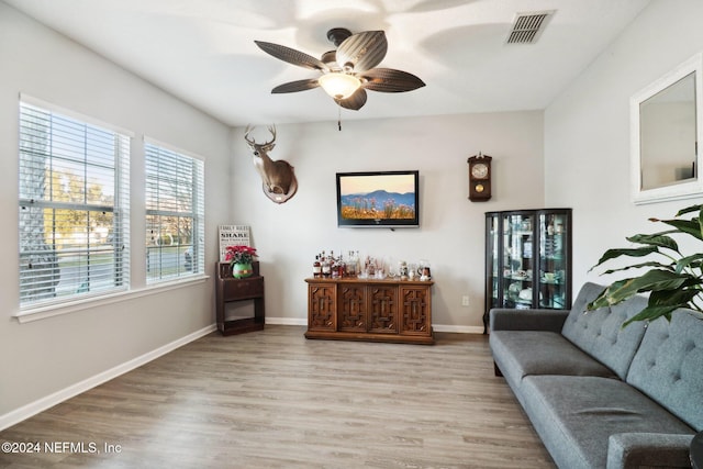 living area featuring ceiling fan and light hardwood / wood-style floors