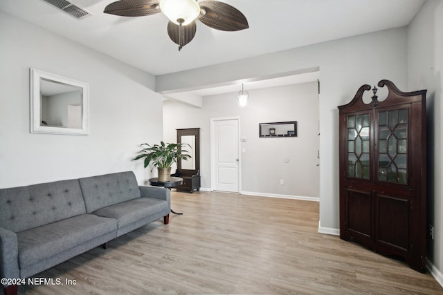 living room featuring ceiling fan and light hardwood / wood-style floors