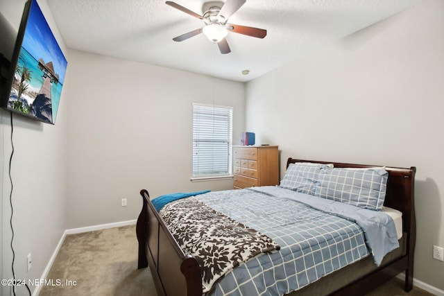 bedroom featuring carpet flooring, a textured ceiling, and ceiling fan