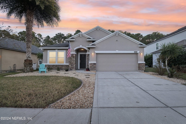 view of front of house with a yard and a garage