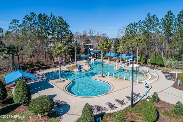 view of swimming pool featuring a patio area and a water slide