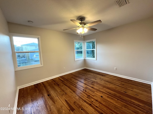 2414 Crill Ave, Palatka, FL 32177 - empty room with dark wood finished floors, baseboards, ceiling fan, and a smoke detector