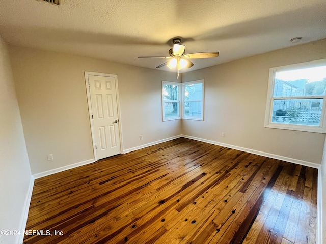 2414 Crill Ave, Palatka, FL 32177 - spare room featuring dark wood-style flooring, ceiling fan, baseboards, a textured ceiling, and a smoke detector