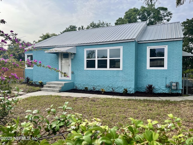2414 Crill Ave, Palatka, FL 32177 - view of front of home featuring brick siding and metal roof