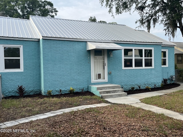 2414 Crill Ave, Palatka, FL 32177 - view of front of property featuring brick siding and metal roof