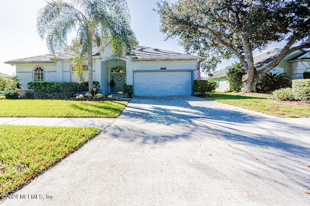 view of front of home featuring a front lawn and a garage