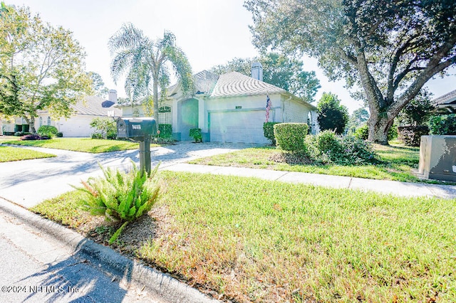 view of property exterior featuring a garage and a yard