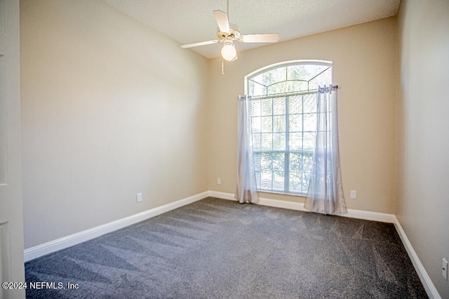 carpeted empty room featuring ceiling fan and a textured ceiling