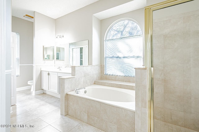 full bathroom featuring tile patterned flooring, vanity, independent shower and bath, and toilet