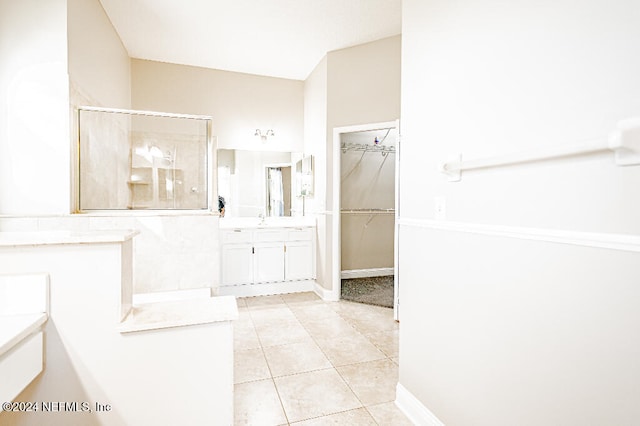 bathroom featuring tile patterned floors, vanity, and an enclosed shower