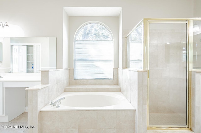 bathroom featuring plus walk in shower and tile patterned flooring