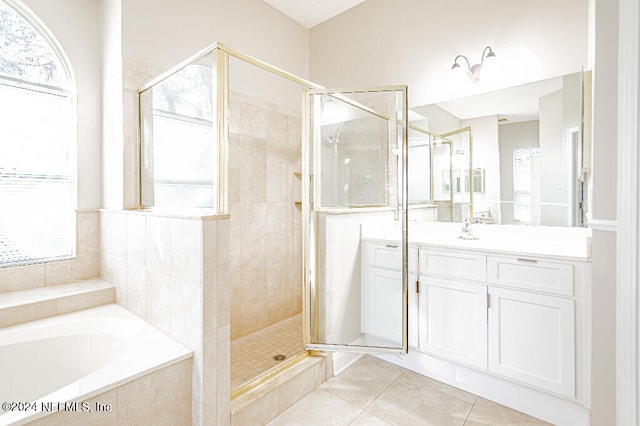 bathroom featuring tile patterned floors, plenty of natural light, vanity, and independent shower and bath