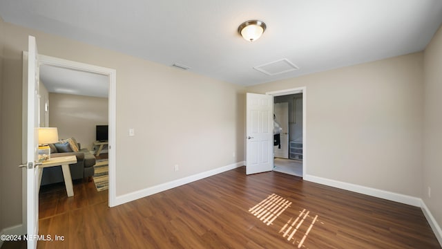 unfurnished bedroom featuring dark hardwood / wood-style flooring