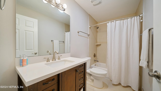 full bathroom featuring tile patterned floors, shower / bath combo with shower curtain, vanity, and toilet