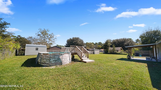 view of yard featuring a swimming pool side deck and a storage shed