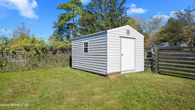 view of outdoor structure featuring a lawn