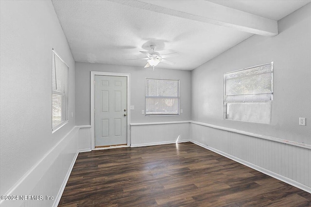 spare room featuring ceiling fan, dark hardwood / wood-style flooring, and lofted ceiling with beams