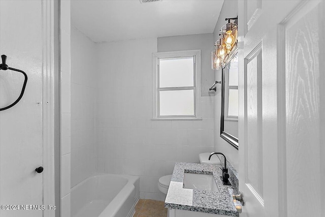 full bathroom featuring tiled shower / bath combo, tile patterned flooring, toilet, vanity, and tile walls