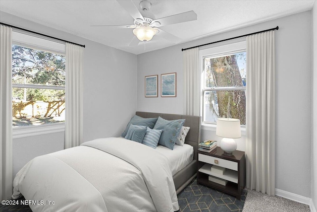 carpeted bedroom with ceiling fan