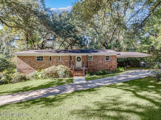 single story home with a front lawn and a carport