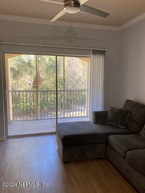 living room with ceiling fan, a healthy amount of sunlight, and wood-type flooring