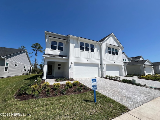 88 Latham Dr, Ponte Vedra, FL 32081 - modern inspired farmhouse with a garage, board and batten siding, decorative driveway, and a front yard