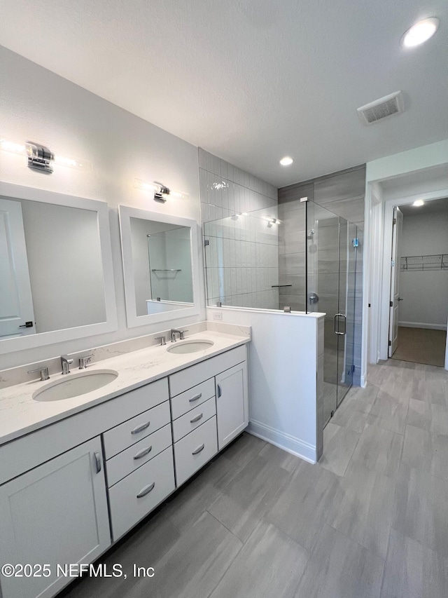 88 Latham Dr, Ponte Vedra, FL 32081 - bathroom with a stall shower, double vanity, recessed lighting, and a walk in closet