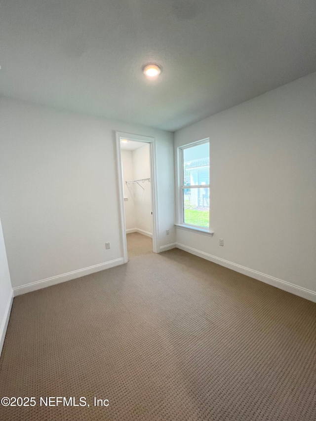 88 Latham Dr, Ponte Vedra, FL 32081 - unfurnished bedroom with baseboards, a spacious closet, light colored carpet, and a closet