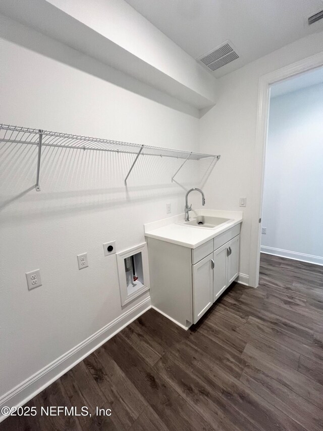 88 Latham Dr, Ponte Vedra, FL 32081 - washroom with dark wood-type flooring, baseboards, electric dryer hookup, cabinet space, and hookup for a washing machine
