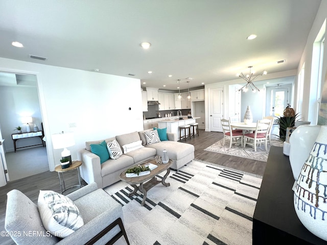 88 Latham Dr, Ponte Vedra, FL 32081 - living area with dark wood-type flooring, recessed lighting, a chandelier, and baseboards