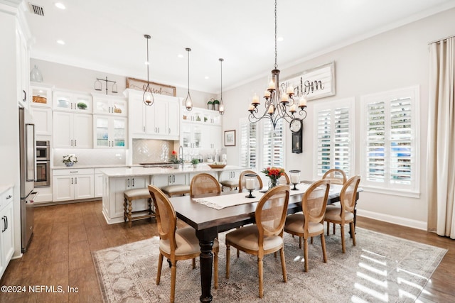 dining area with crown molding, dark hardwood / wood-style flooring, and an inviting chandelier