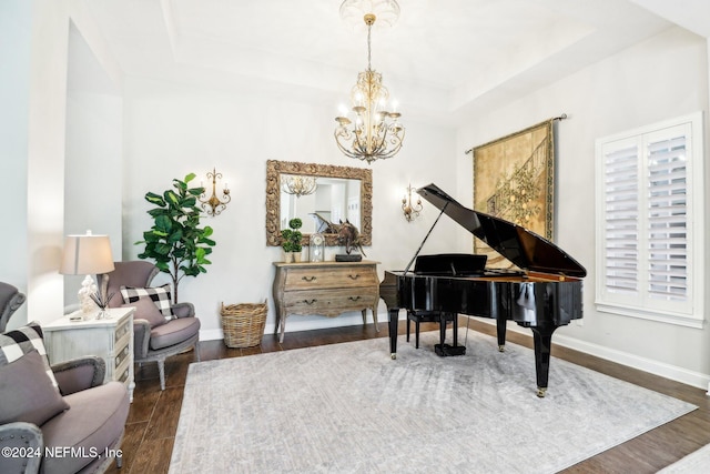 interior space featuring a chandelier, dark hardwood / wood-style flooring, and a tray ceiling