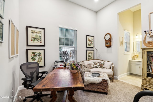 office area featuring light tile patterned floors and a high ceiling