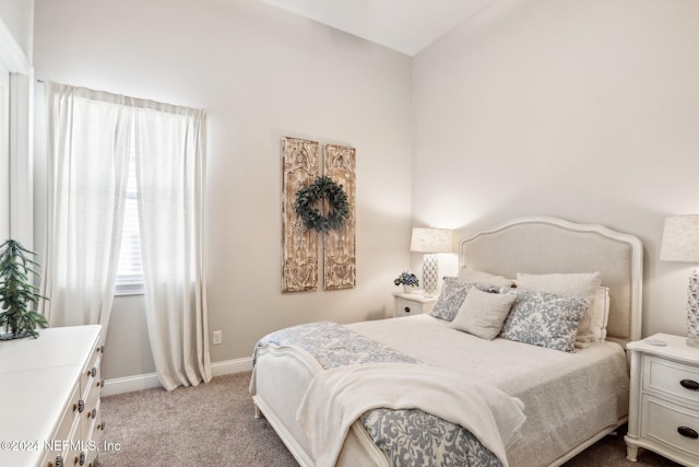 carpeted bedroom featuring vaulted ceiling