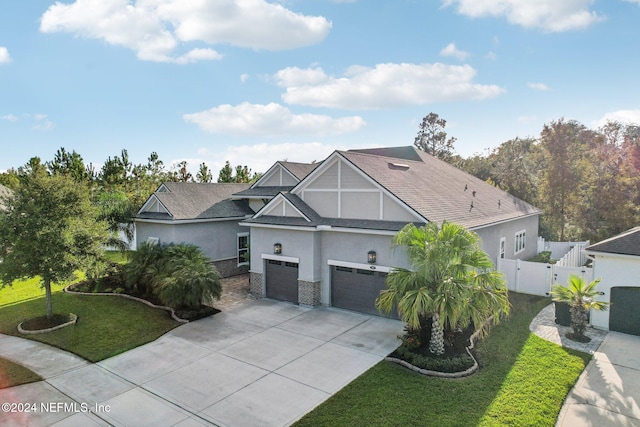 view of front of property featuring a garage and a front lawn