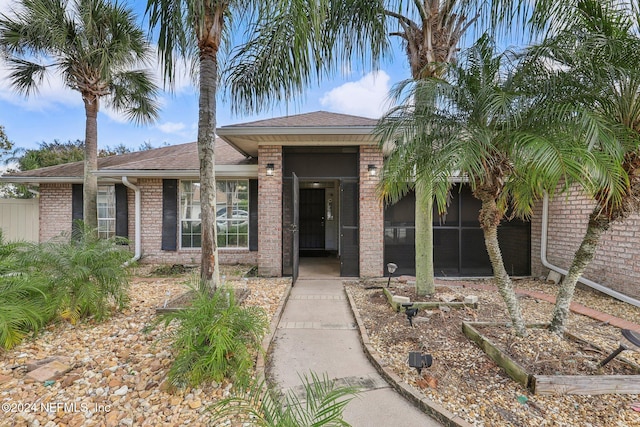 view of front of property featuring a sunroom