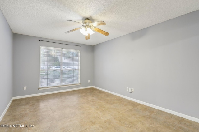 spare room with a textured ceiling and ceiling fan