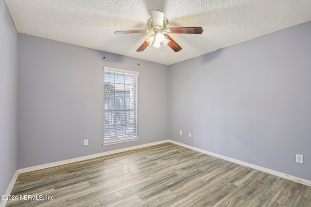 unfurnished room featuring ceiling fan, a textured ceiling, and hardwood / wood-style flooring