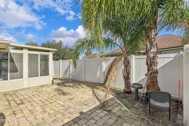 view of patio featuring a sunroom