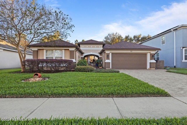 view of front of house with a front lawn and a garage