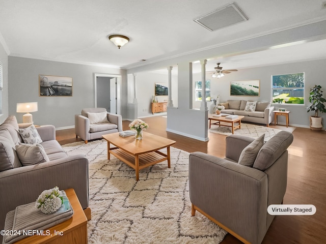 living room featuring light hardwood / wood-style floors, ceiling fan, and ornamental molding