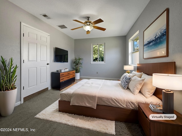 bedroom featuring ceiling fan and dark colored carpet