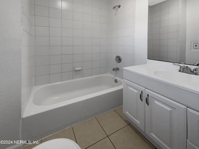 full bathroom with tile patterned floors, vanity, toilet, and tiled shower / bath